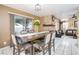 Inviting dining room with stone fireplace, tile flooring, and sliding glass doors to backyard, blending indoor/outdoor living at 5325 Sandstone Dr, Las Vegas, NV 89142