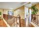 Hallway with wood floors, wood banister, and neutral walls at 5325 Sandstone Dr, Las Vegas, NV 89142
