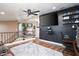 Cozy loft space with dark accent wall, media setup, and a ceiling fan, creating a comfortable entertainment area at 5325 Sandstone Dr, Las Vegas, NV 89142