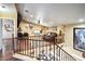 Spacious loft area with hardwood floors, wrought iron railings, and a cozy seating area, great for relaxing at 5325 Sandstone Dr, Las Vegas, NV 89142