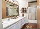 Main bathroom featuring dual sinks, custom mirror, a walk-in shower, and modern fixtures at 5325 Sandstone Dr, Las Vegas, NV 89142