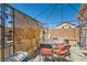 Desert backyard featuring an outdoor dining and seating area under a pergola with privacy screens at 5353 Dandelion Ct, North Las Vegas, NV 89031