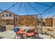 Enjoy this desert backyard with seating under a pergola, dining table, and room to entertain at 5353 Dandelion Ct, North Las Vegas, NV 89031
