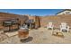 Fully fenced backyard with a desert landscape featuring grills, an outdoor seating area, and room to entertain at 5353 Dandelion Ct, North Las Vegas, NV 89031