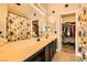Dual vanity bathroom with walk in closet and floral shower curtain at 5353 Dandelion Ct, North Las Vegas, NV 89031