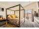 Primary bedroom features vaulted ceiling, carpet flooring, large wooden bed frame and sliding glass door access to backyard at 5353 Dandelion Ct, North Las Vegas, NV 89031