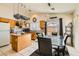 Bright dining area next to kitchen featuring granite countertops, pot rack, and view of the backyard at 5353 Dandelion Ct, North Las Vegas, NV 89031