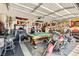Well-equipped garage featuring a pool table, bar stools, and a motorcycle at 5353 Dandelion Ct, North Las Vegas, NV 89031