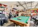 This converted garage includes a pool table, lounge area, a bar, and a motorcycle at 5353 Dandelion Ct, North Las Vegas, NV 89031