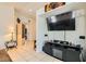 Bright living room featuring neutral tile floors, recessed lighting, and entertainment center with large flatscreen TV at 5353 Dandelion Ct, North Las Vegas, NV 89031