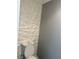Bathroom featuring a toilet with white textured accent wall at 5425 Whisper Bluff St, North Las Vegas, NV 89031