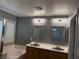 Bathroom featuring double sinks, tub, shower, and natural light at 5425 Whisper Bluff St, North Las Vegas, NV 89031
