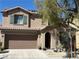 Charming two-story home with a cozy porch, attached garage and drought resistant landscaping at 5425 Whisper Bluff St, North Las Vegas, NV 89031