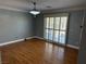 Spacious living room with hardwood floors, ceiling fan, and sliding doors at 5425 Whisper Bluff St, North Las Vegas, NV 89031