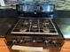 Stove top with black finish and matching oven with black and silver knobs and towel at 5425 Whisper Bluff St, North Las Vegas, NV 89031