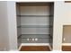 Built-in shelving unit with clear glass shelves and light gray walls in a residential home at 5425 Whisper Bluff St, North Las Vegas, NV 89031