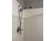 Close up of the shower head in the shower with white tiling at 5425 Whisper Bluff St, North Las Vegas, NV 89031