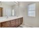 Bright bathroom featuring double sinks with a large mirror, drawers, and a window for natural light at 5588 Holcomb Bridge Ct, Las Vegas, NV 89149