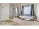 Bathroom featuring soaking tub and glass shower at 5588 Holcomb Bridge Ct, Las Vegas, NV 89149