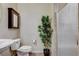 Compact bathroom with a sink, toilet, glass-enclosed shower and modern vanity mirror at 5588 Holcomb Bridge Ct, Las Vegas, NV 89149