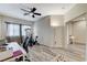 Bedroom with wood floors, desk, and ceiling fan at 5588 Holcomb Bridge Ct, Las Vegas, NV 89149