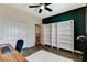 Bedroom with hardwood floors, built-in shelves, and a large closet, perfect for storage and organization at 5588 Holcomb Bridge Ct, Las Vegas, NV 89149