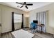 Bright bedroom featuring dark curtains and ceiling fan at 5588 Holcomb Bridge Ct, Las Vegas, NV 89149