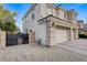 Home exterior featuring a three-car garage and a gated side yard, offering both convenience and security at 5588 Holcomb Bridge Ct, Las Vegas, NV 89149