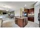 Kitchen area with granite countertops, wood cabinets, center island, and views of dining room at 5588 Holcomb Bridge Ct, Las Vegas, NV 89149