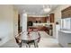 Spacious kitchen and dining area featuring dark wood cabinets and modern appliances at 5588 Holcomb Bridge Ct, Las Vegas, NV 89149
