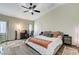 Vaulted ceiling main bedroom featuring wood floors, ceiling fan, and ample natural light at 5588 Holcomb Bridge Ct, Las Vegas, NV 89149
