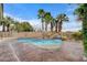 Outdoor pool with waterfall feature surrounded by palm trees, perfect for relaxation and entertaining at 5588 Holcomb Bridge Ct, Las Vegas, NV 89149