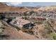Expansive view of luxury homes with a community pool, set against a backdrop of desert hills at 6 Via Vasari # 105, Henderson, NV 89011