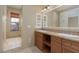 Bathroom with a double sink vanity and separate tub and shower area at 6 Via Vasari # 105, Henderson, NV 89011