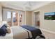 Bedroom featuring a balcony, neutral decor, and an ensuite bathroom at 6 Via Vasari # 105, Henderson, NV 89011