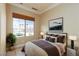 Cozy bedroom with neutral decor, a large window, and plush bedding, creating a relaxing and inviting atmosphere at 6 Via Vasari # 105, Henderson, NV 89011