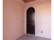Arched wood entry door with view of the interior at 6 Via Vasari # 105, Henderson, NV 89011