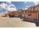 Charming townhome with multiple units, white garage doors and beautiful desert landscaping at 6 Via Vasari # 105, Henderson, NV 89011