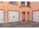 Property with three garage doors each with carriage hardware and a covered entry at 6 Via Vasari # 105, Henderson, NV 89011