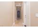 Interior hallway with arched doorway, access to rooms and neutral paint palette at 6 Via Vasari # 105, Henderson, NV 89011