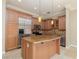 Well-equipped kitchen with stainless steel appliances, granite countertops, custom cabinets, and a functional center island at 6 Via Vasari # 105, Henderson, NV 89011