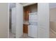 Convenient laundry area with stackable washer/dryer, storage cabinets, and a countertop for folding, optimizing space at 6 Via Vasari # 105, Henderson, NV 89011