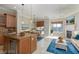 Spacious living and dining area with island, fireplace and access to outdoor living at 6 Via Vasari # 105, Henderson, NV 89011