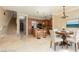 View of the open concept living and dining area with staircase at 6 Via Vasari # 105, Henderson, NV 89011
