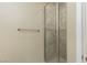Tiled walk-in shower with glass doors and brushed nickel hardware at 6 Via Vasari # 105, Henderson, NV 89011