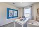 Bright room features a modern desk and chair, creating a functional and inviting workspace at 6152 Aster Garden St # 135, North Las Vegas, NV 89081