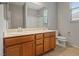 Bathroom featuring double sink vanity, toilet, and window at 640 Finch Island Ave, Henderson, NV 89015