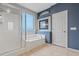 Bathroom with shower, bathtub, and window at 640 Finch Island Ave, Henderson, NV 89015
