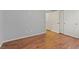 A modest, gray bedroom that features dark, faux wood flooring and a closet at 640 Finch Island Ave, Henderson, NV 89015