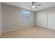 Neutral bedroom with a ceiling fan, window, and closet with sliding doors at 640 Finch Island Ave, Henderson, NV 89015